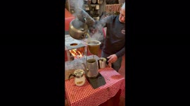 Brazilian man brews coffee the old fashioned way open fire & filtered