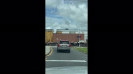 Trains passing each other at railway crossing with flashing lights