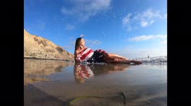 A Beautiful Brunette Model Poses Nude Outdoors With An American Flag