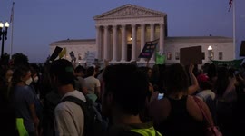 Abortion rights demonstrators rally as night falls at Supreme Court after Roe is overturned