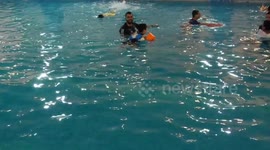 Autistic Palestinian boys swim in a pool during the swimming and water games camp in Gaza city.