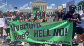 Abortion rights demonstrator addresses rally in front of Supreme Court on day after Roe is overturned