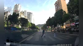 Girl narrowly avoids motorcycle speeding through crossing in China