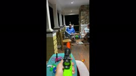 Boy Shoots Can with Nerf Gun