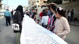 Sons of the Palestinian prisoners take part in a protest as they deliver the longest letter to an international organization in front of Red Cross office in Gaza city.