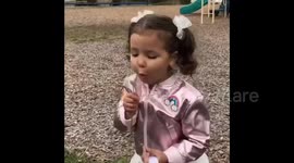 Girl Gets Flower Petals in Mouth
