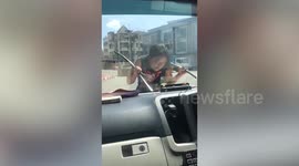 Woman jumps onto ambulance bonnet and destroys its wipers