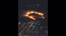 Timelapse shows fire burning through hillside in Athens suburb