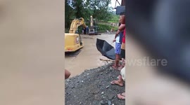 Newlyweds cross swollen river in a BACKHOE to reach church on time after heavy rain