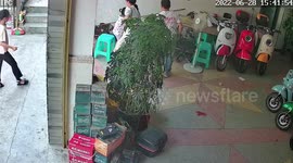 Man avoids being crushed as electric scooter speeds into store in China