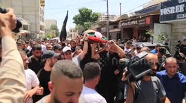 Mourners in West Bank carry the body of Palestinian allegedly killed in Israeli raid