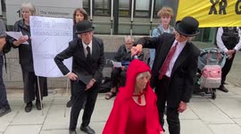 Climate activists pour ‘oil’ on fellow activists outside a government building in London