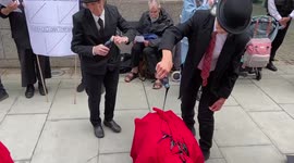 Extinction Rebellion pour 'oil' on fellow activists outside government building in London