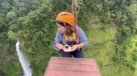 Moch-aahhh! Daredevils sip coffee on table suspended 850ft over waterfall in Laos