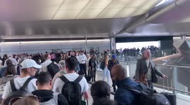 Huge crowd of waiting passengers at London's Heathrow airport
