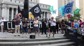 Climate justice protesters sing “Get Up, Stand Up” and “Climate Change Will Rock You” after Supreme Court decision on EPA authority