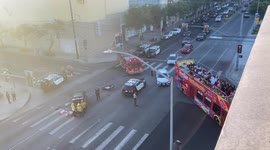 Aftermath of a motorbike crash with a car at sunset in Hollywood with a sight seeing bus driving past