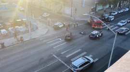 Aftermath of a motorbike crash with a car at sunset in Hollywood with the motorbike rider’s shoes beside the car that hit him