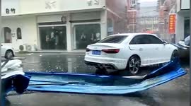 Iron sheets slam onto cars after strong winds rip them off roofs in China