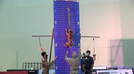 Pit bull terriers run up climbing wall at dog show in Thailand