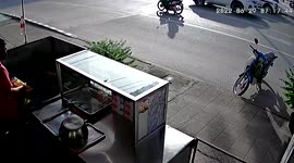 Loose wheel rolls into motorcycle parked outside food shop
