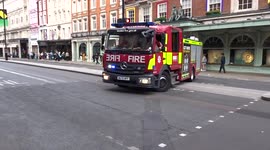 Fire brigade vehicle moves across pedestrian island on Piccadilly - London