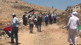 Palestinian protesters clash with Israeli forces during a demonstration against settlements in the village of Beit Dajan
