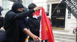 Hong Kong pro-democracy activists in London burn Chinese flag on 25th anniversary of British handover