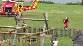 Port Isaac Accident, or a heart attack as the air ambulance lands the medics walk across to the waiting ambulance