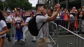 Pride demonstrator gives middle finger to extremist Christians protesting against the event