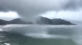 Large waterspout damages buildings after swirling close to coast in southern China