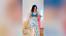 Naughty pet Siberian Husky bites owner's crotch while she tries on new clothes
