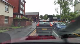 Dashcam view of near miss at traffic lights after they turn to red.