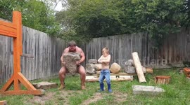Aussie man goes viral for workout with son where they launch huge ROCKS and TYRES across garden