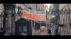 People outside 10 Downing Street after UK gov't rocked with resignations