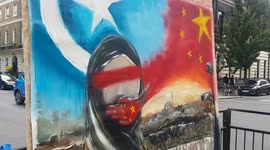 Artist paints haunting live protest piece in support of Uyghurs in China