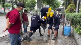 'Chain gangs' from local prison clean blocked drains in Bangkok, Thailand