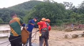 Buddhist monks zipline over raging river following heavy rain in northern Thailand
