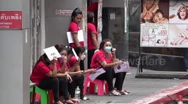 Massage girls wait for customers as tourists return to Bangkok's red-light strip