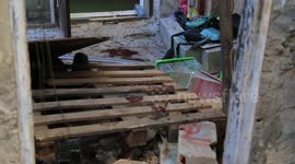 Family of Amid Arsan inspect their home after a raid by Israeli troops to arrested him