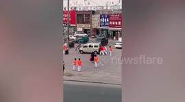 Women push minibus away as they need space to dance in China