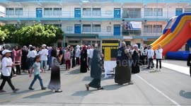 Palestinian schoolgirls perform a simulated pilgrimage celebrating the upcoming Islamic pilgrimage and Eid al-Adha festival during a summer camp by run by the United Nations Relief and Works Agency (UNRWA)