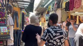 Palestinians shop at a market ahead of the Muslim festival of sacrifice Eid al-Adha