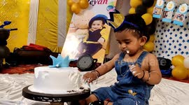 A funny sweet baby boy played with Birthday cake