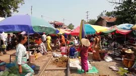 Train runs through market as vendors frantically clear fresh food and parasols from tracks