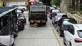 Reversing rubbish truck knocks over woman playing on her phone while walking in China