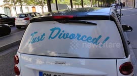 Sun car visor reading -Just divorced- (humour with -Just Married-). Paris,France. 10 july 2022