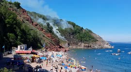 Emergency services have been called out to a woodland fire near Devon beach