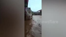 Burmese village flooded by mountain runoff after heavy rain