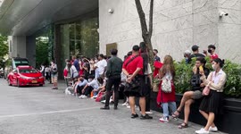Manchester United supporters wait outside team hotel in Bangkok, Thailand